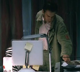 Anton, the movie’s protagonist, stands in front of an iMac whose Apple logo is covered with a Post-It note.