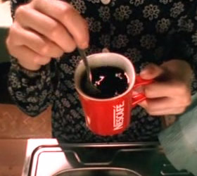 Svetlana, one of the female focuses of the film, stirs her Nescafé coffee in her red Nescafé mug.